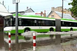 Autobus na wodzie i piesi na bosaka. Krajobraz po burzy w Białymstoku