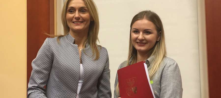 Karolina Komorowska odbiera podpisaną umowę z rąk Sylwii Jaskulskiej