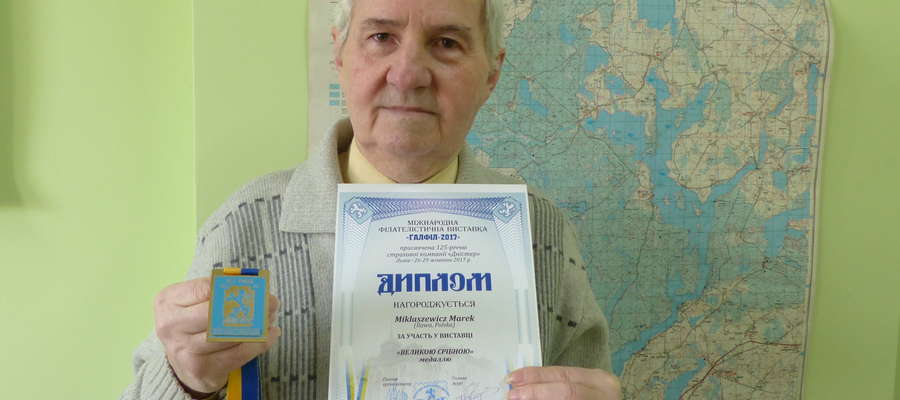 Marek Mikłaszewicz, filatelista z Iławy prezentuje dyplom i medal po wystawie we Lwowie