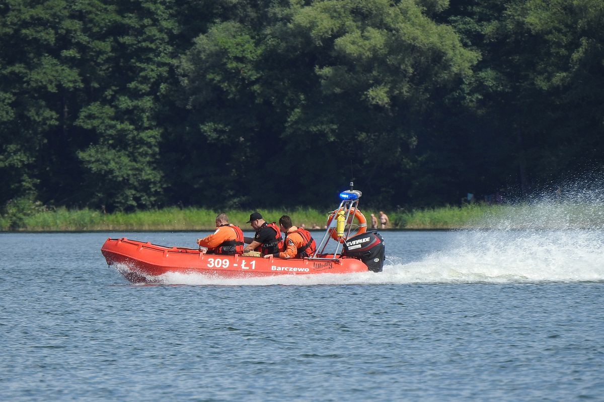 Strażacy pędzą łodzią na ratunek po wypadku skutera wodnego nad jeziorem Dadaj.