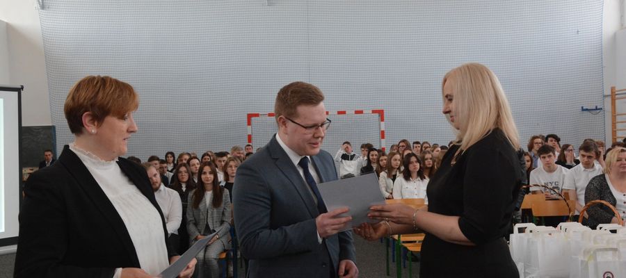Dyrektor I LO w Olecku Katarzyna Kamińska wręcza nagrodę Laur Kochanowskiego Krzysztofowi Bielawskiemu. Gratulacje otrzymała też jego mama Karina Bielawska